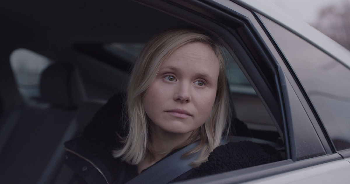 Alison Pill looking out the back car seat window in All My Puny Sorrows