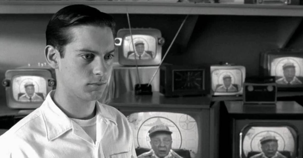Tobey Maguire in front of televisions with Don Knotts on them in Pleasantville