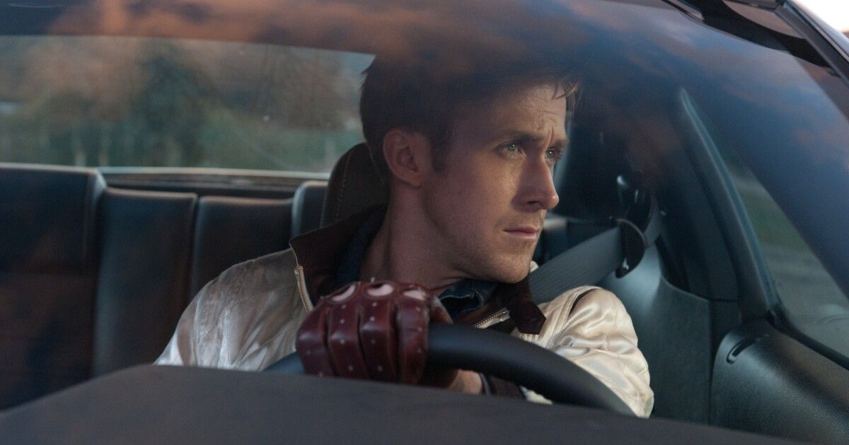 Ryan Gosling looking out a car window in the driver seat in Drive