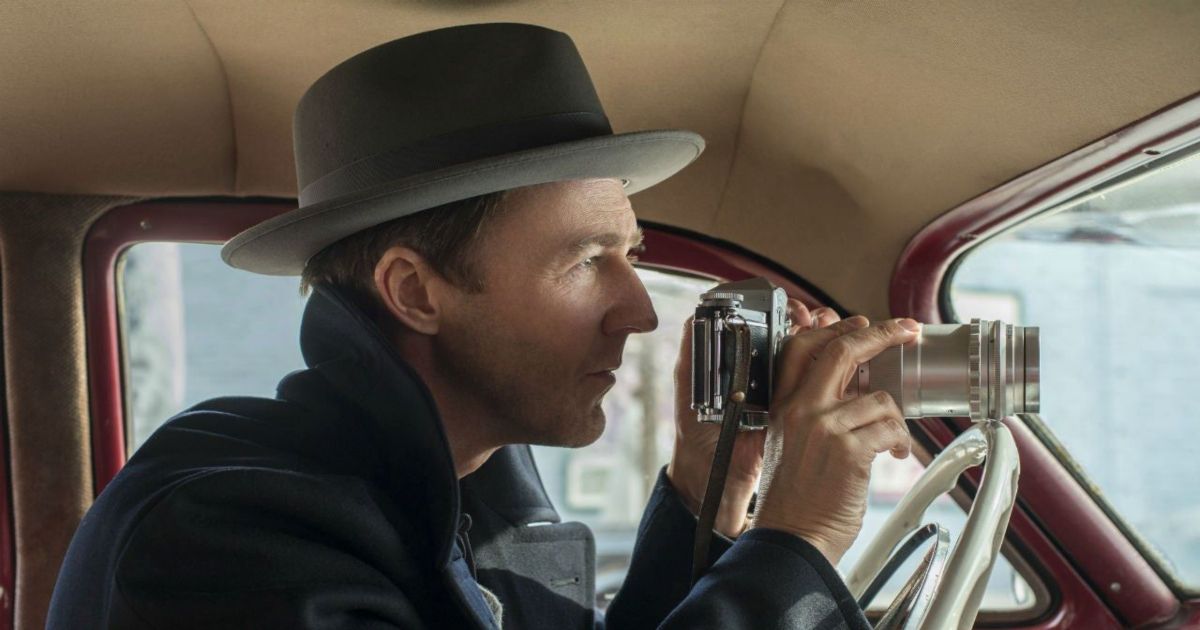 Edward Norton with a camera in a car in Motherless Brooklyn