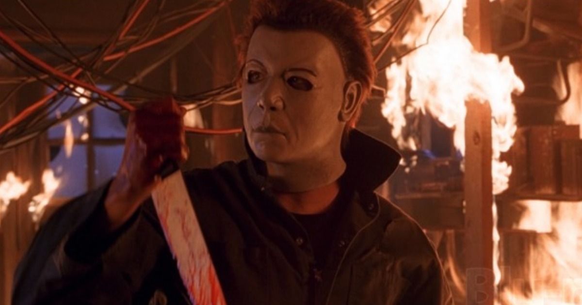 Michael making a final stand with a knife in a burning building in Halloween Resurrection