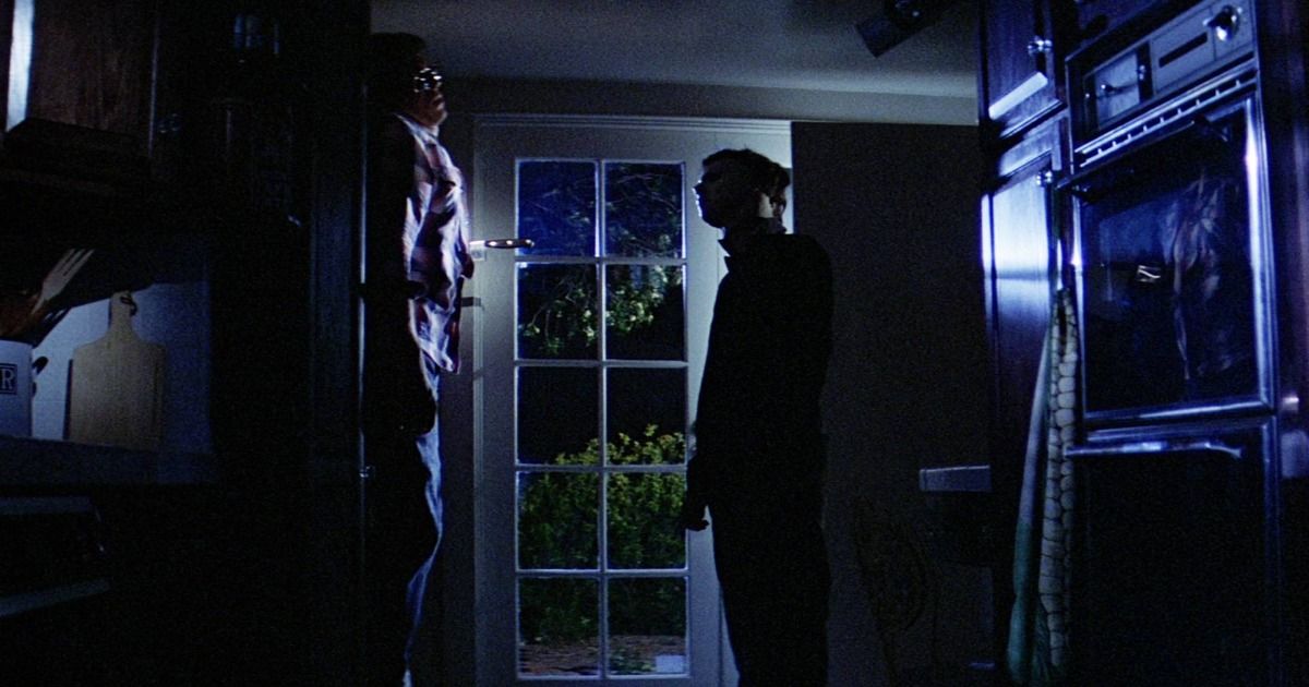 Michael Myers stabs Bob in a dark house in Halloween