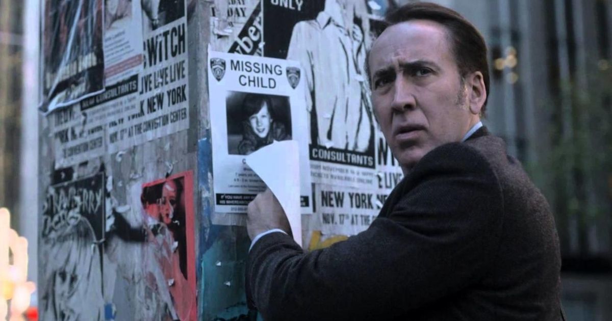 Nicolas Cage in Pay the Ghost, a pole covered in posters in front of him