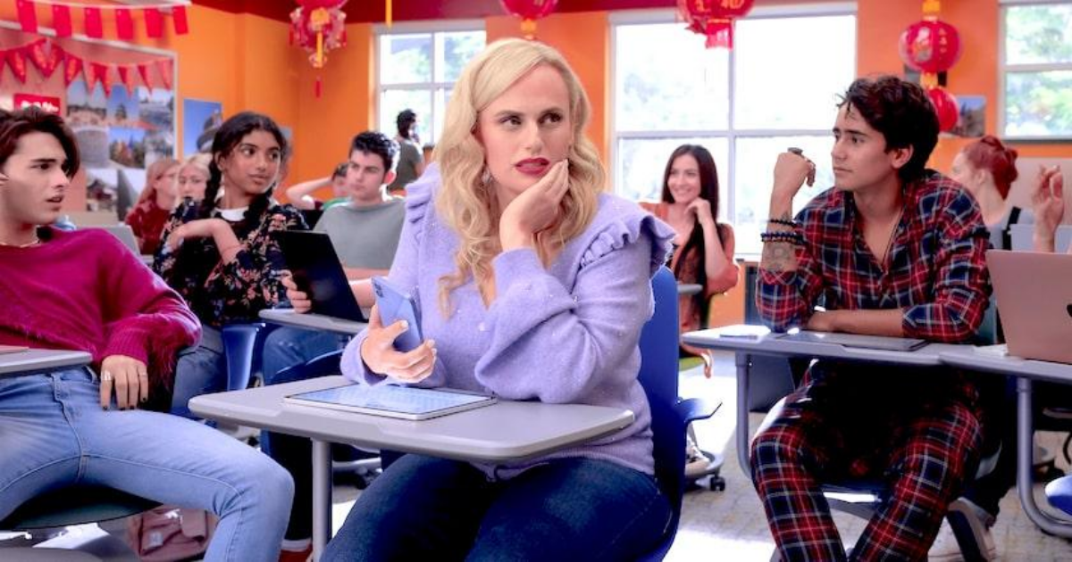 Rebel Wilson sits in a classroom in Senior Year