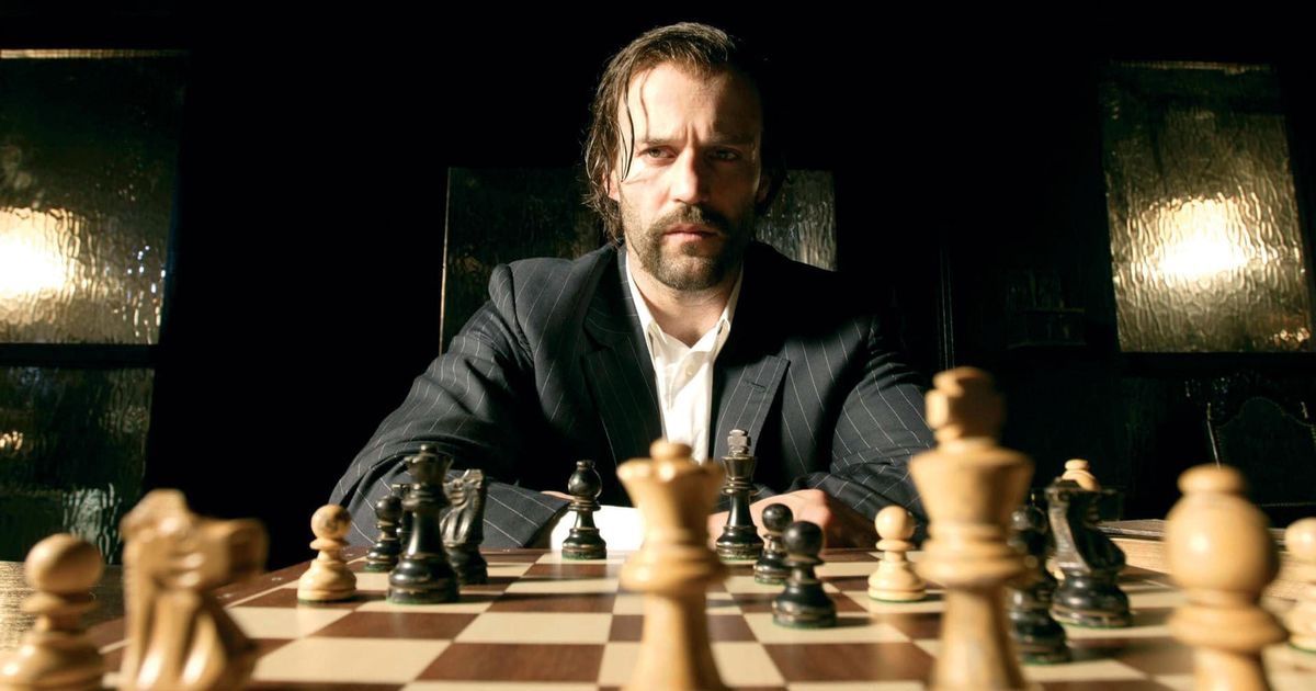 Man sits in front of chess board in Revolver from Guy Ritchie