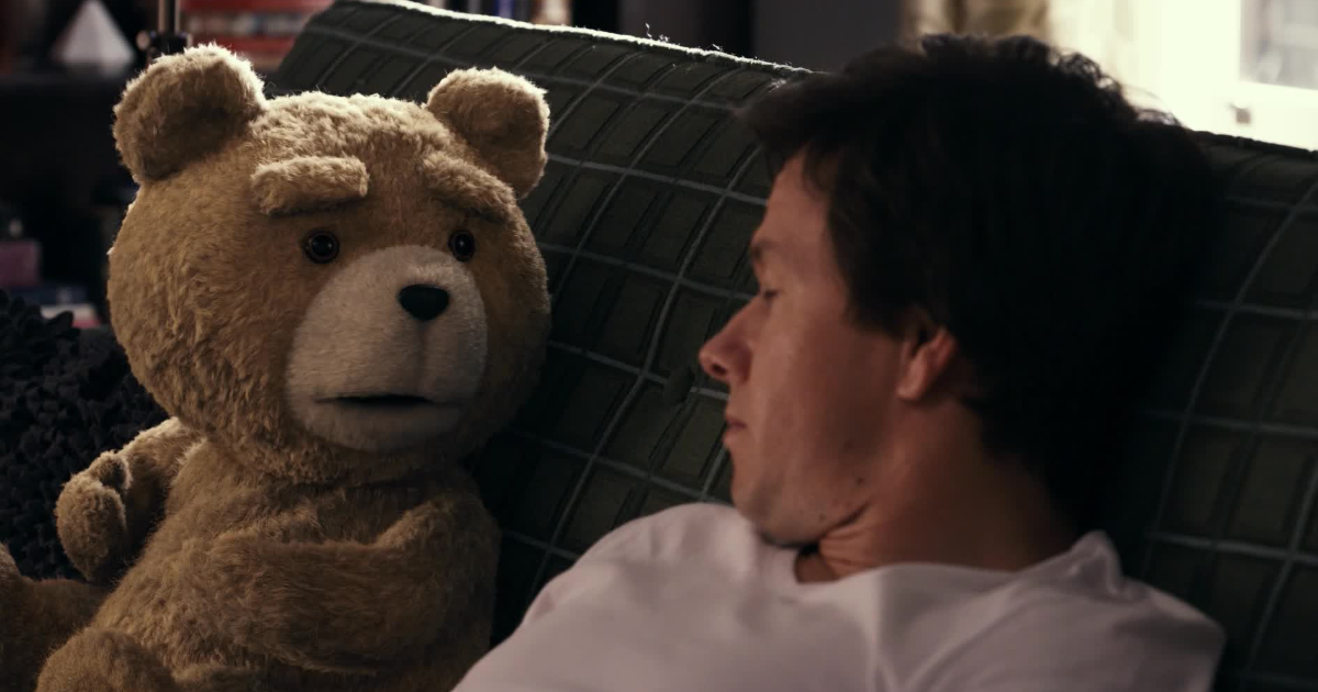 Ted and Mark Wahlberg on a couch
