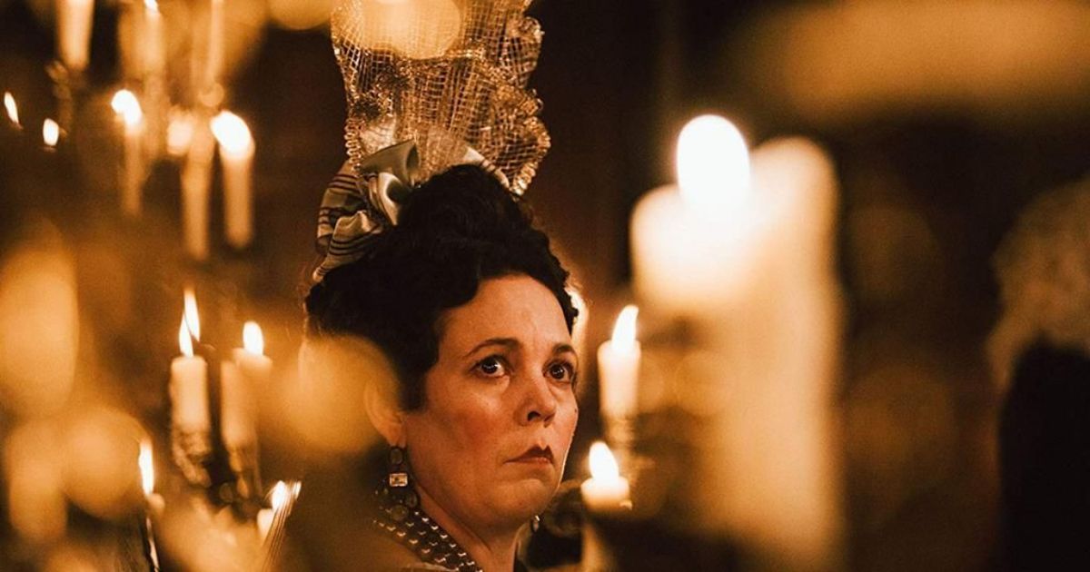 Olivia Colman surrounded by candlelight as Queen Anne in The Favourite