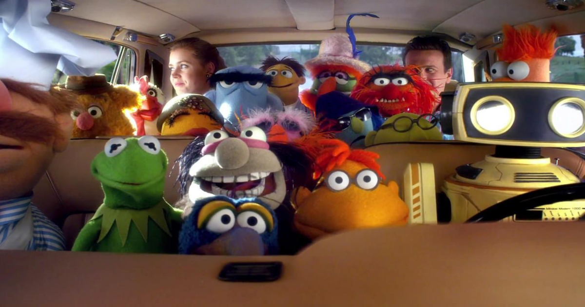 The Muppets cast of muppets in a van with Jason Segal