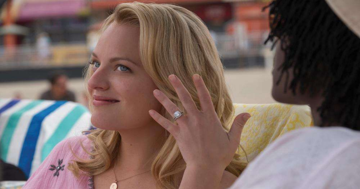 Elisabeth Moss shows off her ring in US