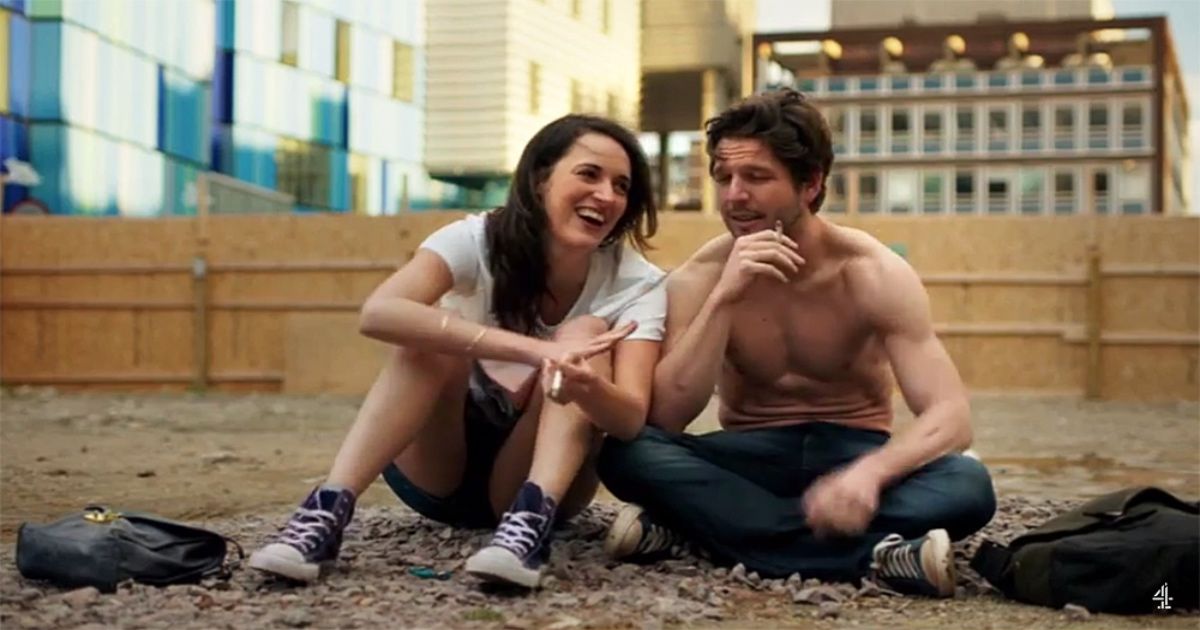 two people sat laughing on beach