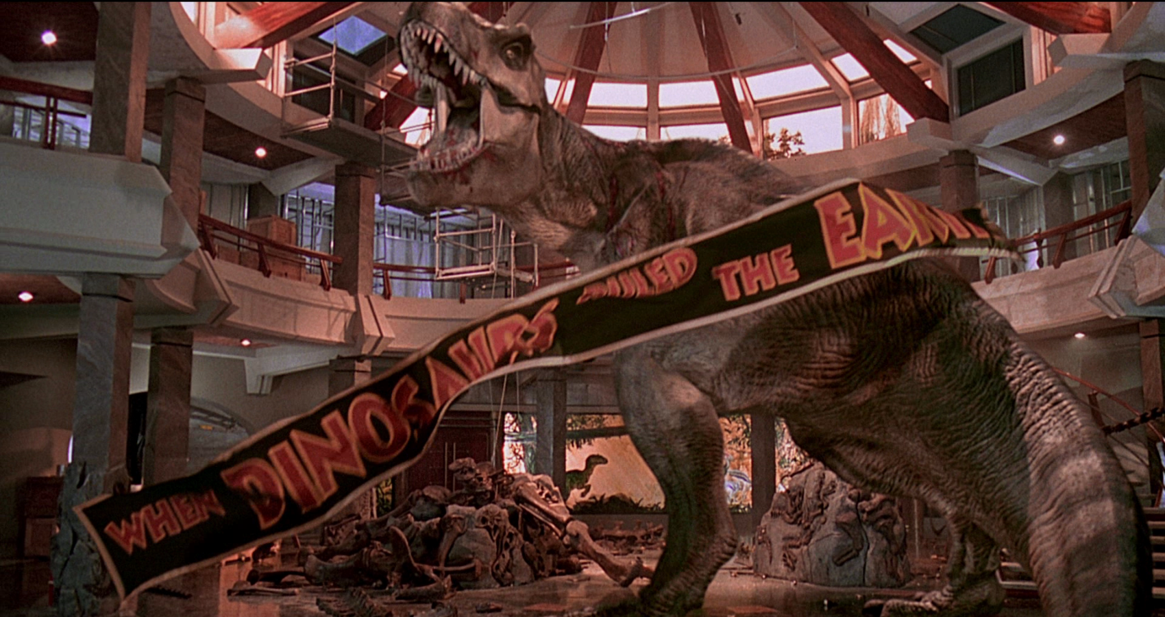 The sign is located in front of the T Rex