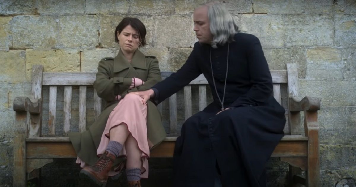 Jessie Buckley and Rory Kinnear on a bench in Men