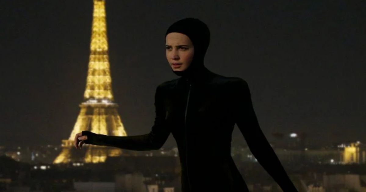 Alicia Vikander on the roof in the catsuit with the Eiffel Tower behind her in Irma Vep 2022