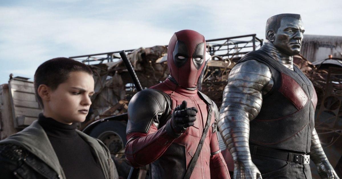 Deadpool looks at the camera, breaking the 4th wall, next to two mutant friends in a junkyard.