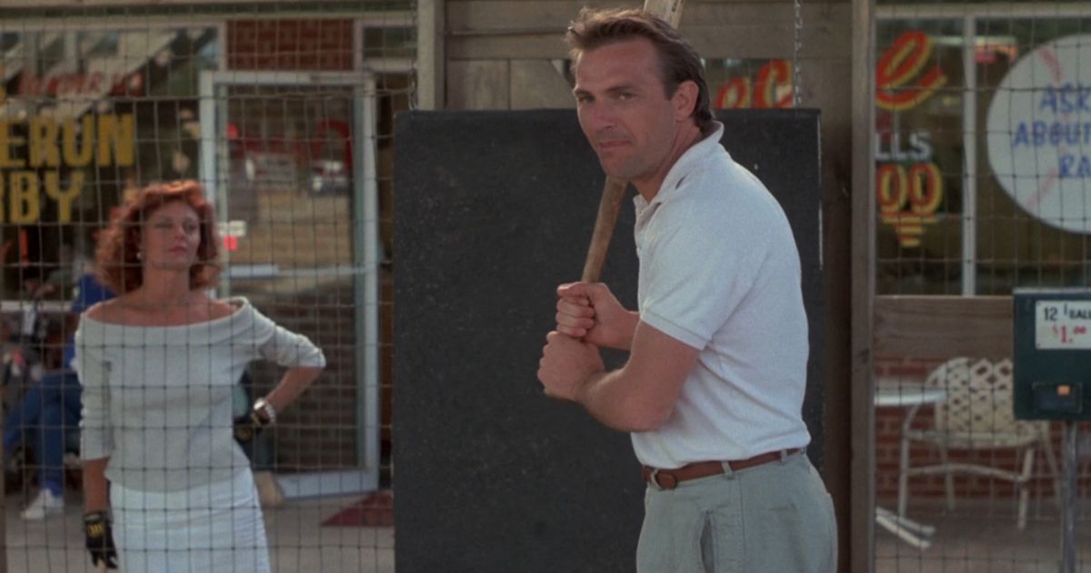 Kevin Costner with a baseball bat while Susan Sarandon watches in Bull Durham
