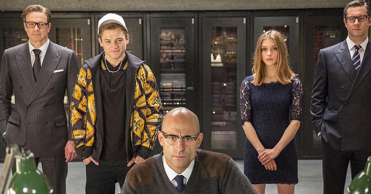 Harry (Collin Firth), Eggsy (Taron Egerton), Roxy (Sophie Cookson) and another Kingsman scans the situation with Merlin (Mark Strong)