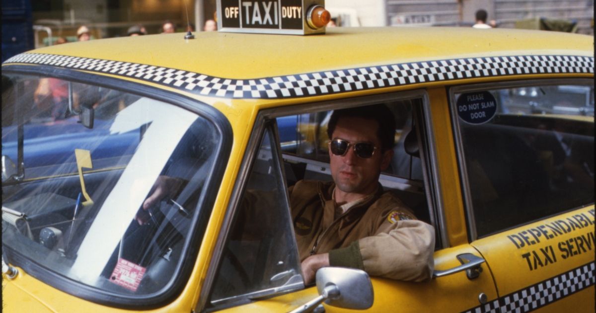 Robert De Nero in a bright yellow taxi in Taxi Driver