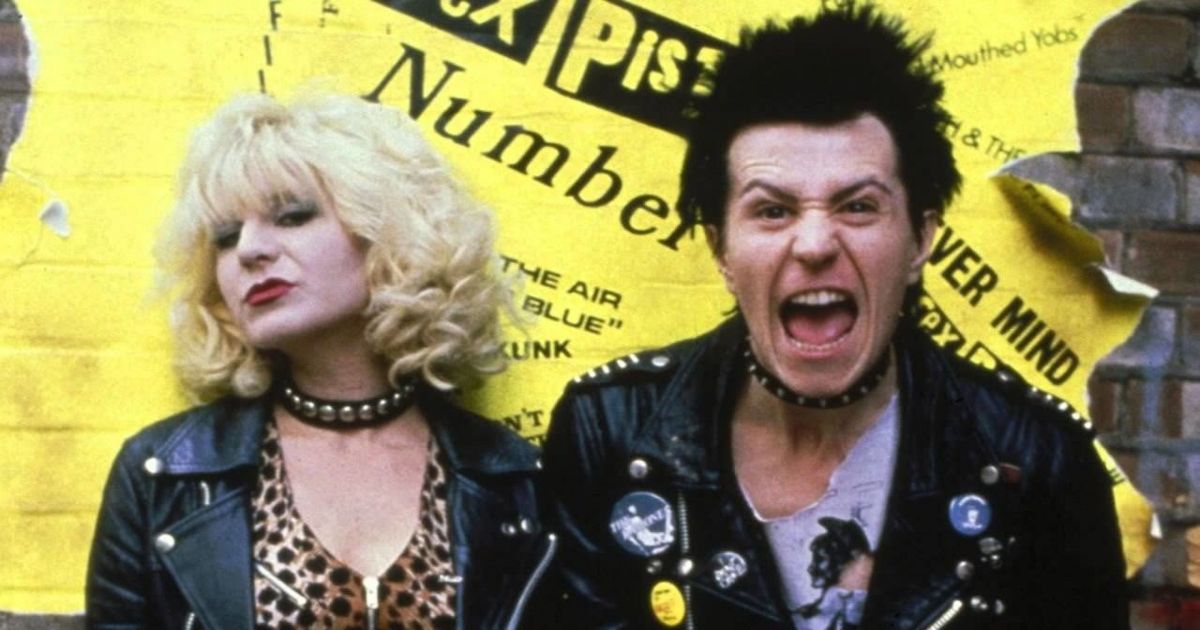 Sid and Nancy yell at the screen in front of a yellow building