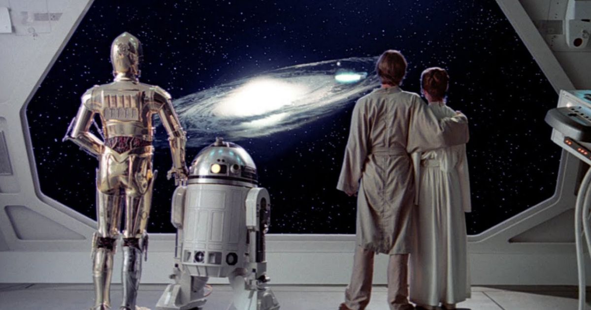 Luke and Leia and C3P0 and R2D2 watch an explosion in Star Wars Return of the Jedi 