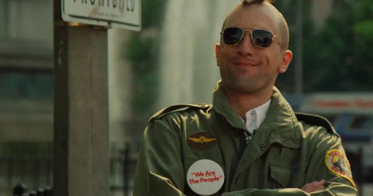 Robert DeNiro smiles with his short mohawk and soldier's uniform in Taxi Driver