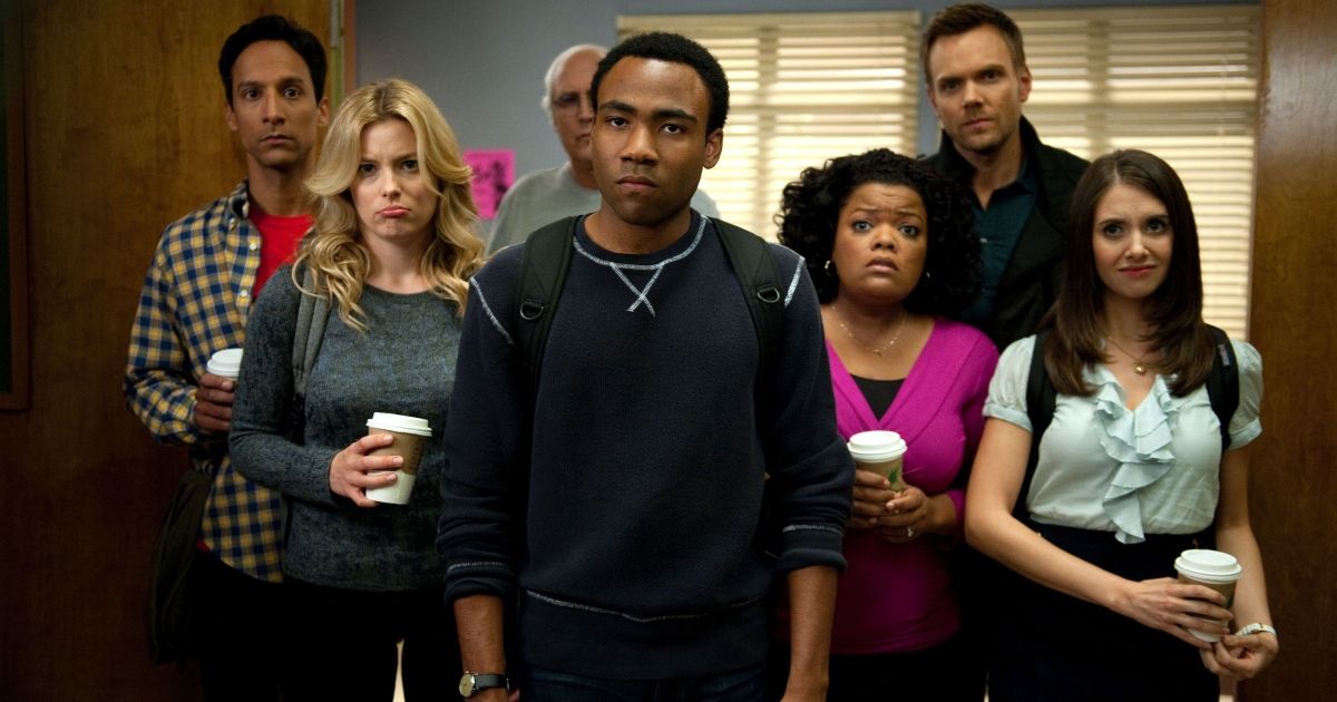The cast of Community all holding coffee and looking upset