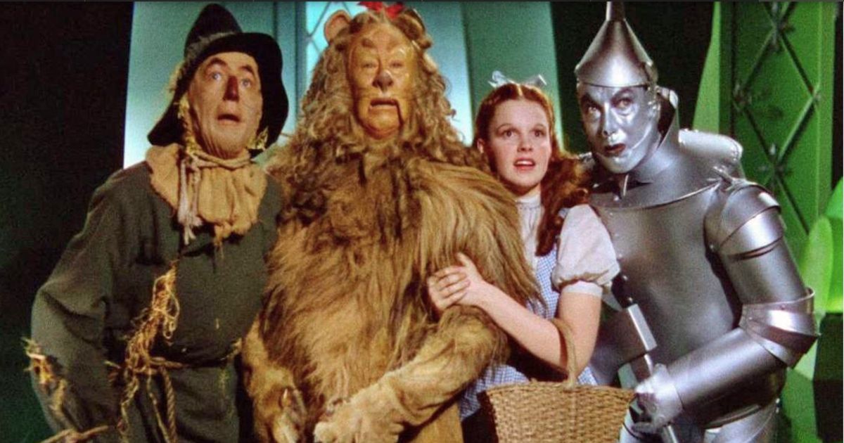 Ray Bolger as the Scarecrow/Hunk, Bert Lahr as the Cowardly Lion/Zeke, Judy Garland as Dorothy, and Jack Haley as The Tin Man/Hickory in The Wizard of Oz