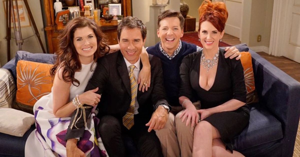The cast of Will and Grace poses on the couch.