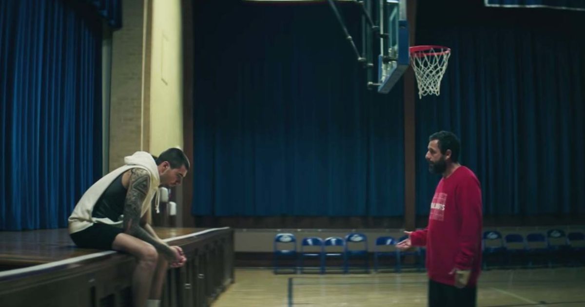 Adam Sandler coaching a basketball player in Hustle