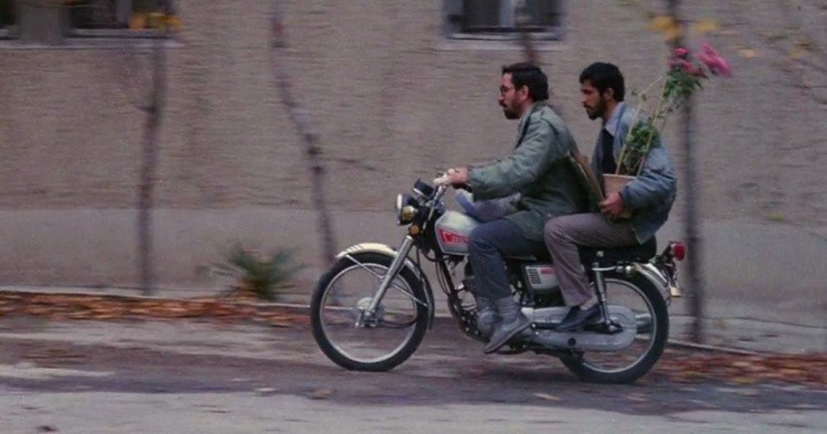 Two men on a motorcycle in Close-Up from Abbas Kiarostami