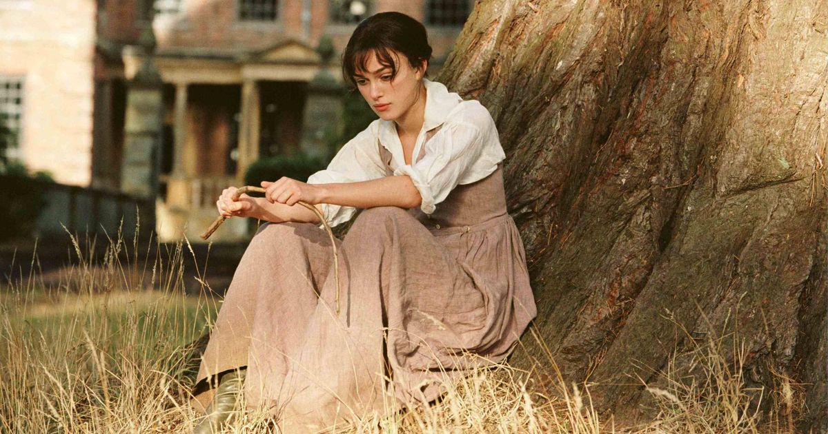 Lizzy (Keira Knightley) sits under a tree.