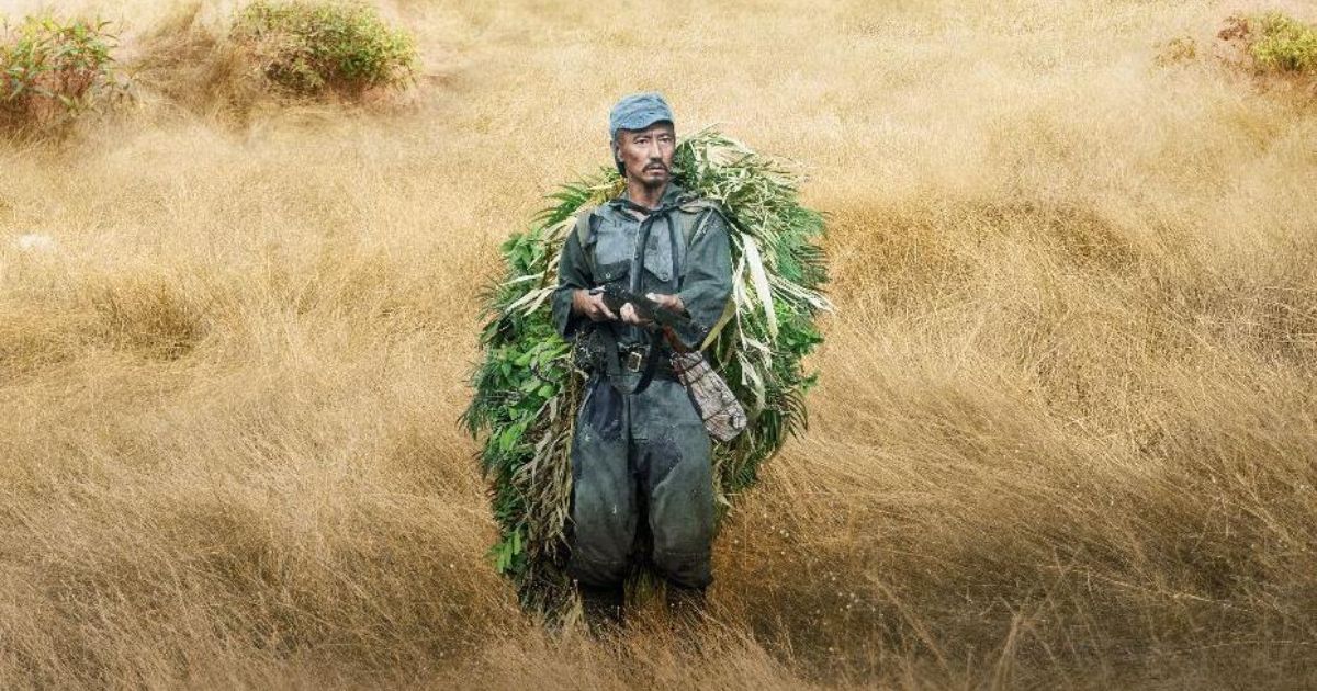 Hiroo Onoda walks through a field in 10,000 Nights in the Jungle 