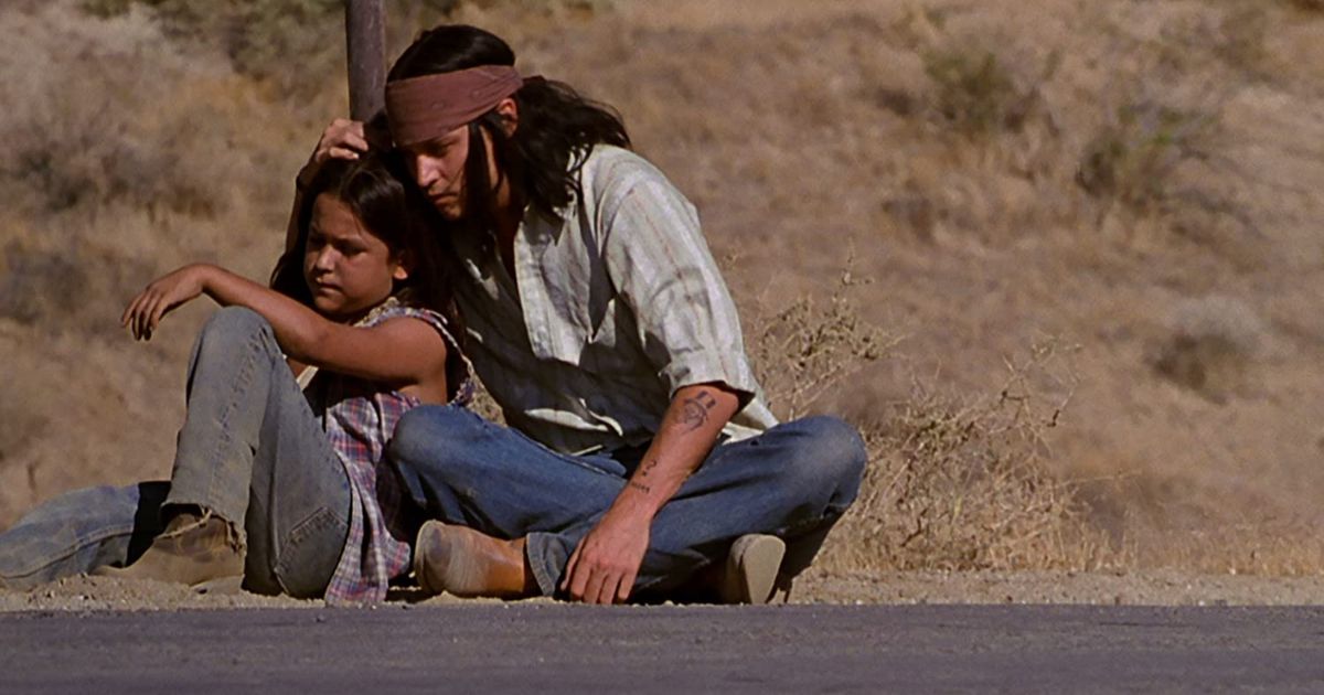 Johnny Depp as the Indigenous Raphael and his son in his movie The Brave