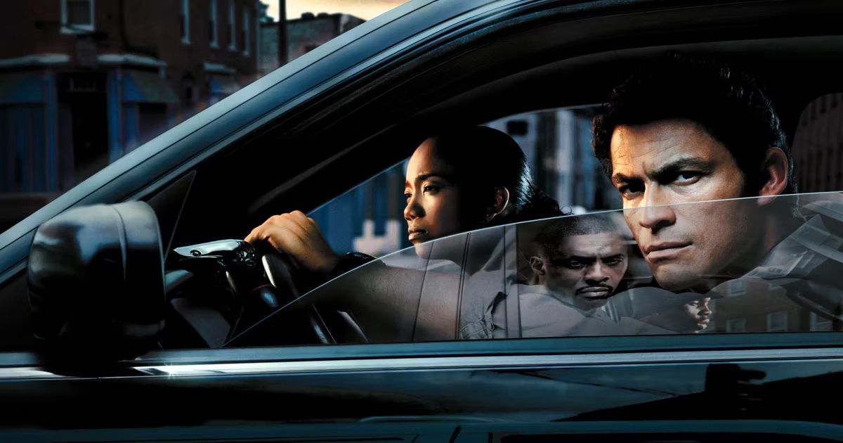 McNulty and other cops in the car as a drug dealer is reflected in the car window in The Wire