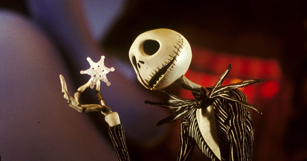 Jack Skellington from The Nightmare Before Christmas looks at a snowflake and examines it.