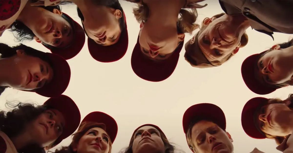 The cast of women huddle in the 2022 remake of A League of Their Own