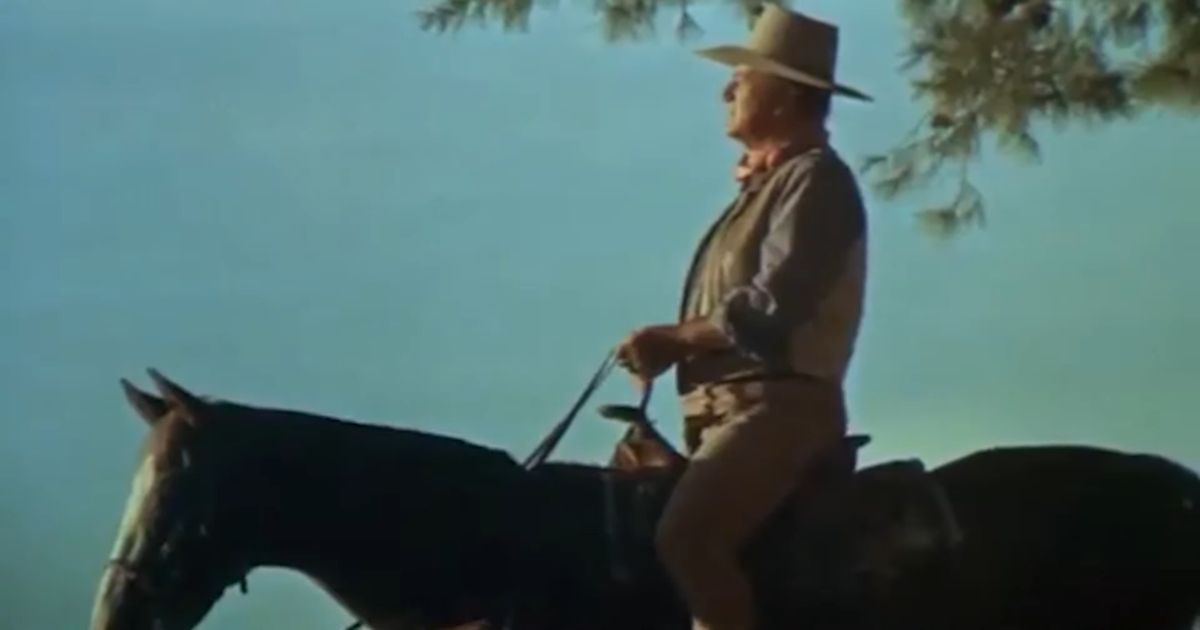 John Wayne riding a horse in Chisum (1970)