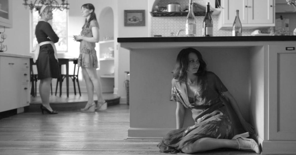 Amy Acker hides in the kitchen in order to listen in Much Ado About Nothing 