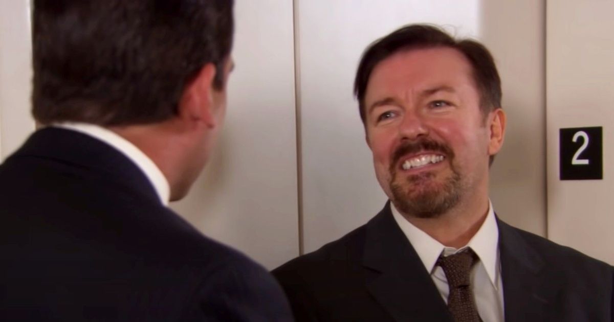 Ricky Gervais laughing in the middle of a conversation