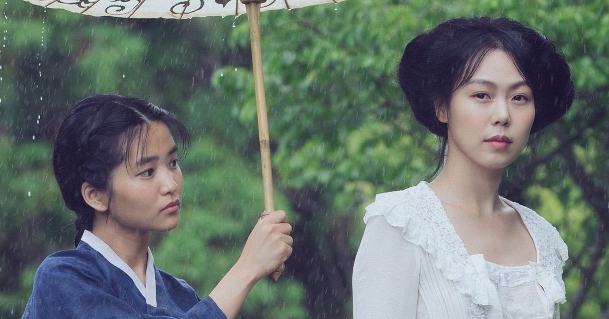 Woman holds umbrella for another woman in The Handmaiden.