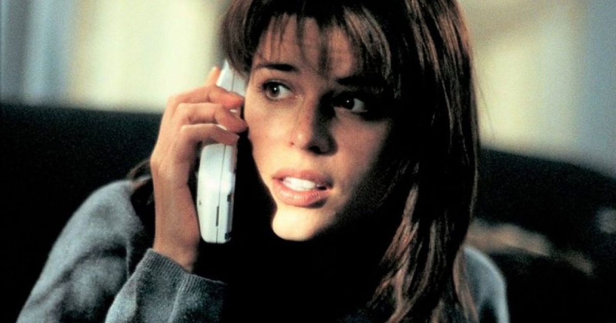 Neve Campbell as Sidney Prescott, holding a phone next to her ear in Scream 1996