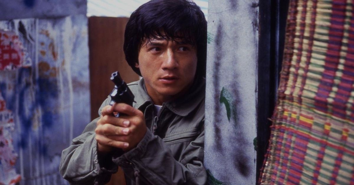 Jackie Chan holding a pistol