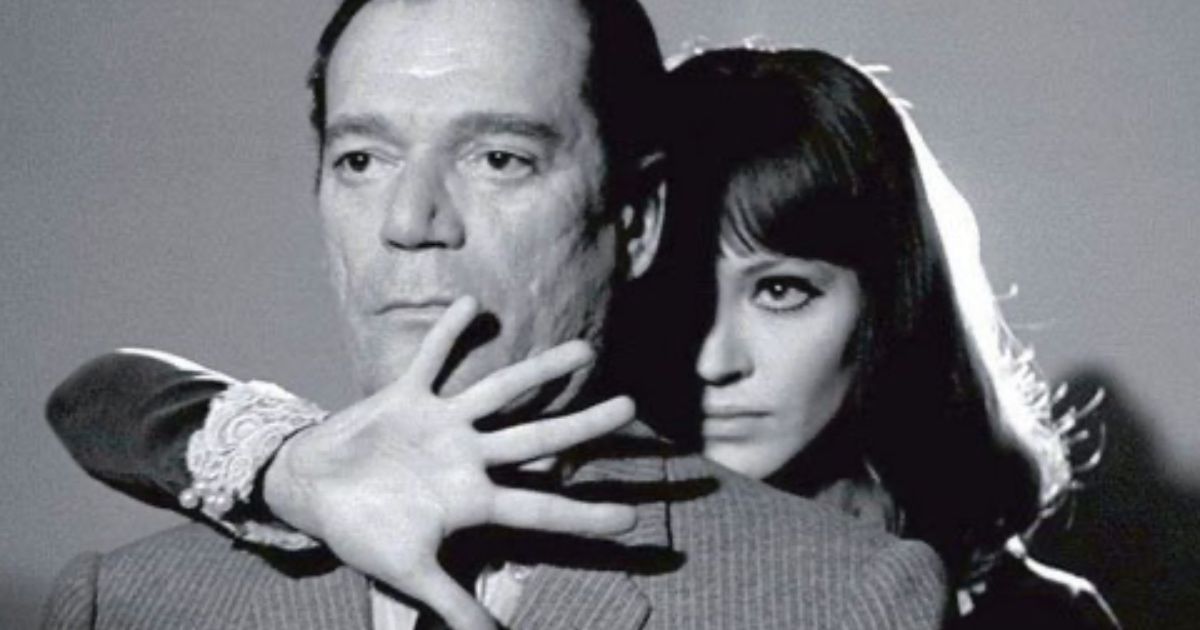 Woman holds hand in front of man in Alphaville