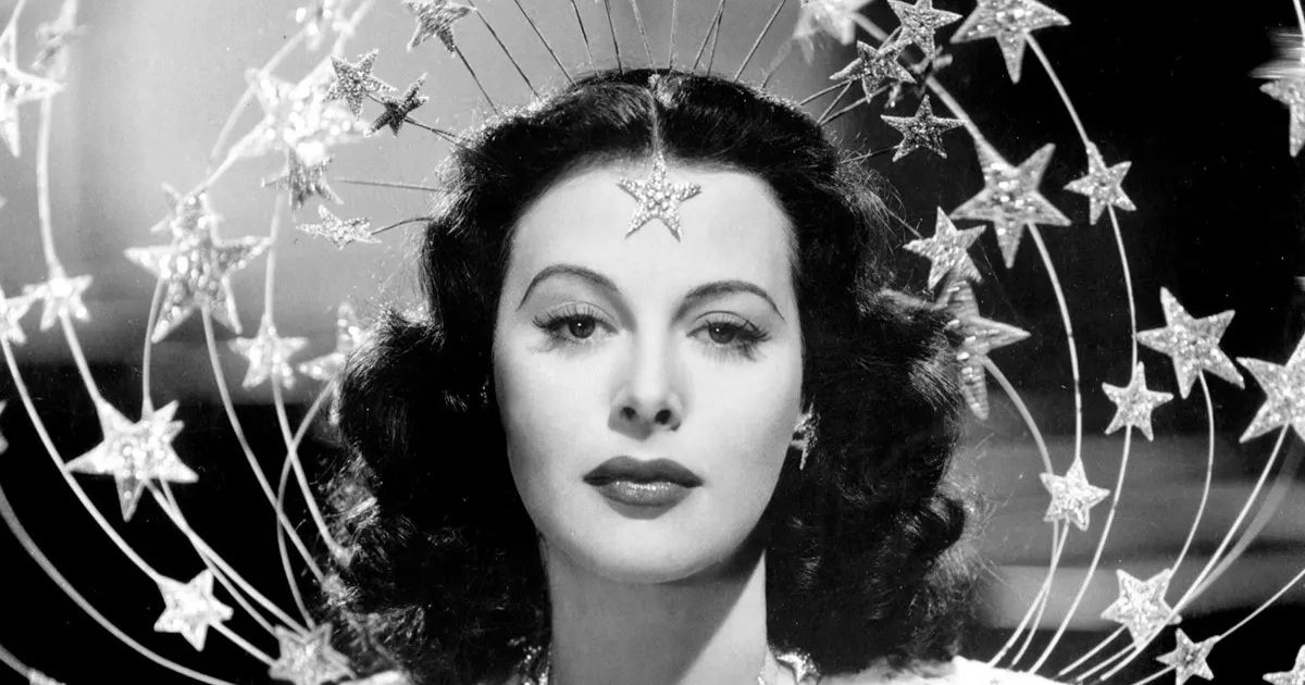 Hedy Lamarr stands with star headpiece around her.