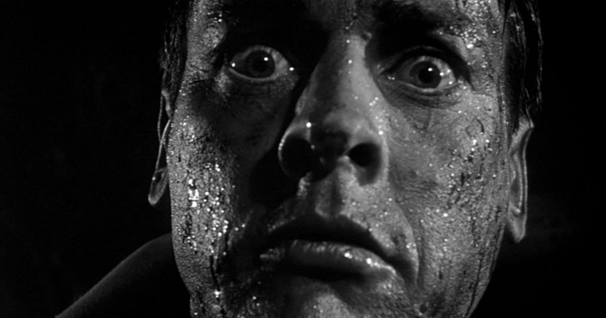 Kevin McCarthy's face, covered in mud, looks terrified in Invasion of the Body Snatchers 1956 movie