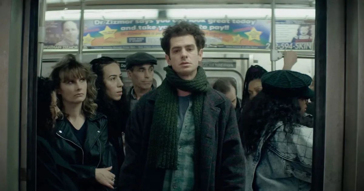 Andrew Garfield looks tired and sad in a subway car in tick, tick...Boom!