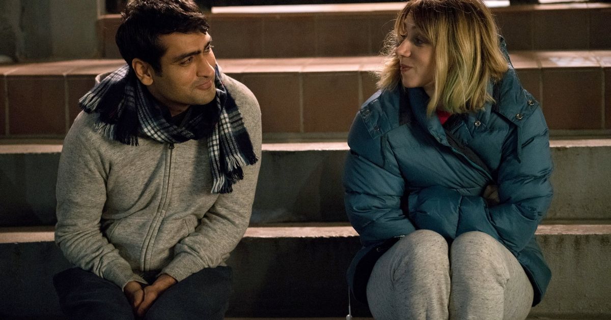 Man and Woman sit on outdoor stairs and stare into each others eyes in the Big Sick