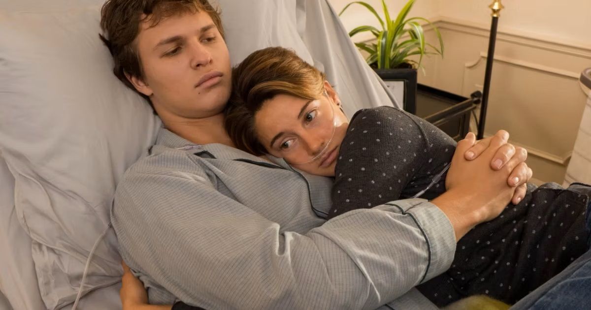 Shailene Woodley and Ansel Elgort lay together in a hospital bed in the Fault In Our Stars