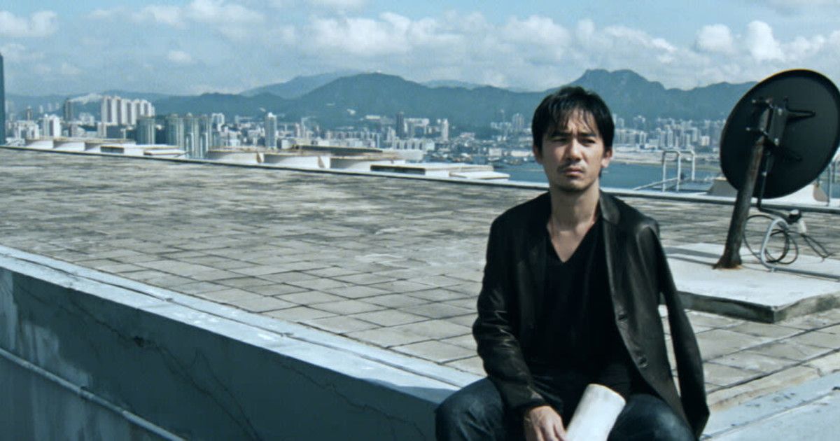 Tony Leung sits on a roof in Infernal Affairs