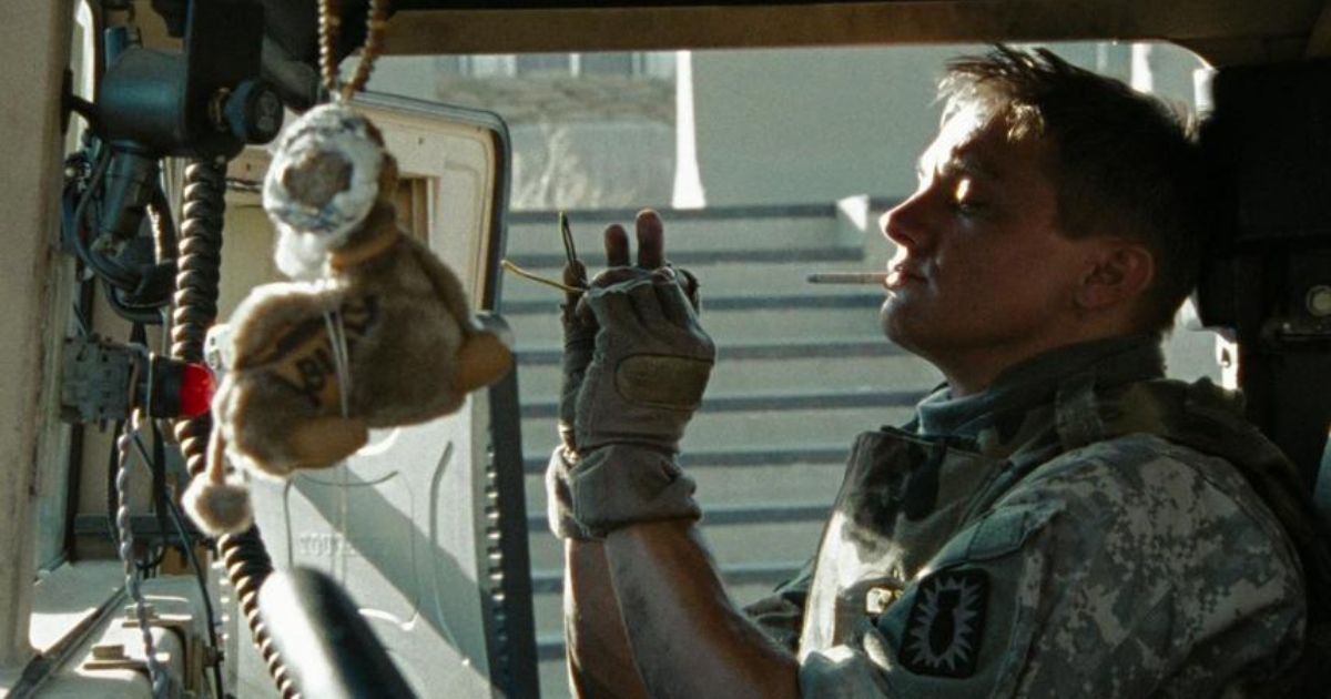 The Hurt Locker's Jeremy Renner is sitting in his truck smoking a cigarette