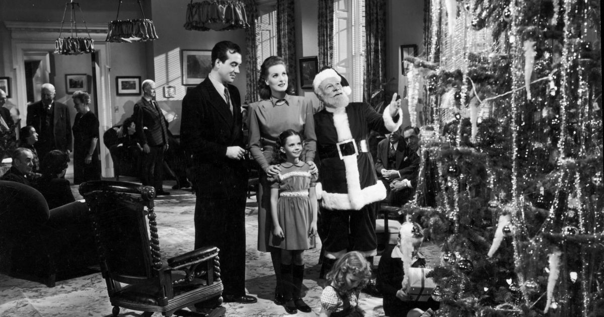 Kris Kringle, Doris, Fred and Susan looks at the Christmas tree.